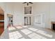 Open living room with fireplace, built-ins, and view of second story and kitchen at 4617 S Cobblestone Dr, Zionsville, IN 46077