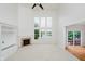 Bright living room features fireplace, built-ins, and large windows with a backyard view at 4617 S Cobblestone Dr, Zionsville, IN 46077
