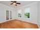 Home office with hardwood floors, a ceiling fan, french doors, and bright natural light at 4617 S Cobblestone Dr, Zionsville, IN 46077
