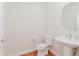 Simple powder room with pedestal sink and hardwood flooring at 4617 S Cobblestone Dr, Zionsville, IN 46077