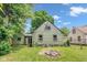 This image showcases the home's backyard, with a firepit and green house at 4708 Haverford Ave, Indianapolis, IN 46205