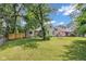The backyard features a well-manicured lawn, mature trees, and a fire pit at 4708 Haverford Ave, Indianapolis, IN 46205