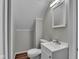 Bathroom featuring light gray walls, wood look flooring, and a small vanity at 4708 Haverford Ave, Indianapolis, IN 46205