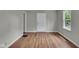 Neutral bedroom with hardwood floors and a large window at 4708 Haverford Ave, Indianapolis, IN 46205