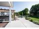 Backyard oasis featuring a pergola-covered hot tub, dining area, fire pit and hammock swing at 4992 Fennel Dr, Pittsboro, IN 46167