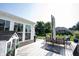Inviting deck area with seating, playhouse, and a view of the expansive, well-maintained backyard at 4992 Fennel Dr, Pittsboro, IN 46167