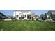 Expansive backyard featuring manicured landscaping, dining, firepit and hammock swing at 4992 Fennel Dr, Pittsboro, IN 46167