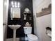 Modern half bath featuring a pedestal sink, decorative shelves, and contemporary lighting at 4992 Fennel Dr, Pittsboro, IN 46167