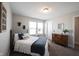 Bright bedroom featuring carpet, natural light, and a cozy bed adorned with decorative pillows at 4992 Fennel Dr, Pittsboro, IN 46167