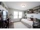 Bright bedroom with ample natural light, wall shelving, carpet, and comfortable bed at 4992 Fennel Dr, Pittsboro, IN 46167