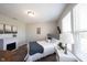 Cozy bedroom with natural light, a faux fireplace, and decoratively appointed with a comfy bed at 4992 Fennel Dr, Pittsboro, IN 46167