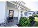 Inviting front porch with rocking chairs and well-maintained landscaping at 4992 Fennel Dr, Pittsboro, IN 46167