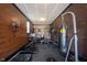 Home gym featuring exposed brick, modern equipment, rubber flooring, and ample workout space at 4992 Fennel Dr, Pittsboro, IN 46167