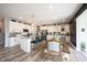 Open kitchen with white cabinets, granite countertops, stainless steel appliances, and an island with bar seating at 4992 Fennel Dr, Pittsboro, IN 46167