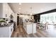 Bright, open kitchen with an island, granite countertops, stainless steel appliances, and a view to the dining area at 4992 Fennel Dr, Pittsboro, IN 46167