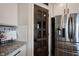 Stainless steel refrigerator and pantry door with glass panes in a modern kitchen design at 4992 Fennel Dr, Pittsboro, IN 46167