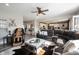 Inviting living room open to the kitchen featuring a large sectional sofa, wood floors, and stylish decor at 4992 Fennel Dr, Pittsboro, IN 46167
