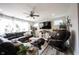 Open-concept living room featuring a large sectional sofa, a ceiling fan, and a mounted TV above a farmhouse style console at 4992 Fennel Dr, Pittsboro, IN 46167
