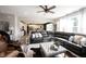 Spacious living room with an open view to the kitchen, featuring a large sectional sofa and a modern ceiling fan at 4992 Fennel Dr, Pittsboro, IN 46167