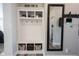 Mudroom with storage cubbies, hooks, decorative mirror and tile flooring at 4992 Fennel Dr, Pittsboro, IN 46167