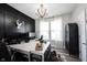 Well-lit home office featuring a large desk, modern decor, and black accent wall at 4992 Fennel Dr, Pittsboro, IN 46167
