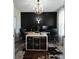 Modern home office with black accent wall, a large white desk, and stylish decor at 4992 Fennel Dr, Pittsboro, IN 46167