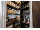 Walk-in pantry with custom wood shelves, baskets, and ample storage space at 4992 Fennel Dr, Pittsboro, IN 46167