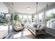 Bright sunroom with a swing, chair and lots of windows offering serene backyard views at 4992 Fennel Dr, Pittsboro, IN 46167