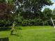 Lush backyard with a clothesline and mature trees at 509 Eberhart Dr, Shelbyville, IN 46176