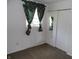Bedroom featuring neutral carpet, closet with mirrored doors, and floral curtains at 509 Eberhart Dr, Shelbyville, IN 46176