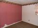 Bedroom featuring pink patterned wallpaper, neutral carpet, and a decorative border near the ceiling at 509 Eberhart Dr, Shelbyville, IN 46176