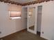 Bedroom with a closet with mirrored doors, neutral carpet, and natural light from the window at 509 Eberhart Dr, Shelbyville, IN 46176