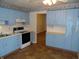 Kitchen featuring blue cabinetry, a black stove and range at 509 Eberhart Dr, Shelbyville, IN 46176