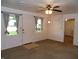 Cozy living room with neutral-toned carpet and fan at 509 Eberhart Dr, Shelbyville, IN 46176