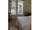 Bright bedroom featuring neutral walls and a double window with vertical blinds at 5304 Appleseed Way, Indianapolis, IN 46217