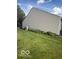 Side view of home showing well-maintained vinyl siding and manicured lawn at 5304 Appleseed Way, Indianapolis, IN 46217