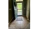 Inviting foyer with ceramic tile flooring, view of door and coat rack at 5304 Appleseed Way, Indianapolis, IN 46217