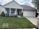 Charming home featuring a covered porch, manicured lawn, and a two-car garage at 5304 Appleseed Way, Indianapolis, IN 46217