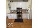 Updated kitchen with stainless steel appliances, gas range, white cabinetry, and granite countertops at 5304 Appleseed Way, Indianapolis, IN 46217