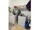 Functional laundry area with a washer and dryer plus convenient shelving for storage at 5304 Appleseed Way, Indianapolis, IN 46217