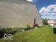 Side view of home showing well-maintained vinyl siding and manicured lawn at 5304 Appleseed Way, Indianapolis, IN 46217