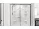 Bathroom shower with glass doors, built-in shelving and white tile at 5409 Brandywine Dr, Whitestown, IN 46075