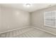 Cozy bedroom with plush carpet, a window with blinds, and ample natural light at 5409 Brandywine Dr, Whitestown, IN 46075