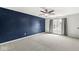 Bedroom boasts a modern dark accent wall, plush carpeting, fan and a window with natural light at 5409 Brandywine Dr, Whitestown, IN 46075