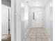 Bright foyer with neutral tile flooring, offering a glimpse of the interior with ample natural light at 5409 Brandywine Dr, Whitestown, IN 46075