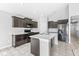 Modern kitchen features dark cabinets, stainless steel appliances, an island, and white countertops at 5409 Brandywine Dr, Whitestown, IN 46075