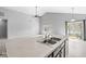 Kitchen island with stainless sink, marble countertops and views of a living room with a sliding patio door at 5409 Brandywine Dr, Whitestown, IN 46075
