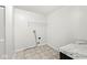 A laundry room featuring tile flooring, washer and dryer hookups, and a marbled countertop at 5409 Brandywine Dr, Whitestown, IN 46075
