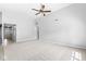 Spacious living room with carpet, open to the kitchen, featuring high ceilings and ample natural light at 5409 Brandywine Dr, Whitestown, IN 46075