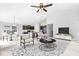 Staged living room with modern furniture, showcasing an open layout with a view of the kitchen and dining area at 5409 Brandywine Dr, Whitestown, IN 46075